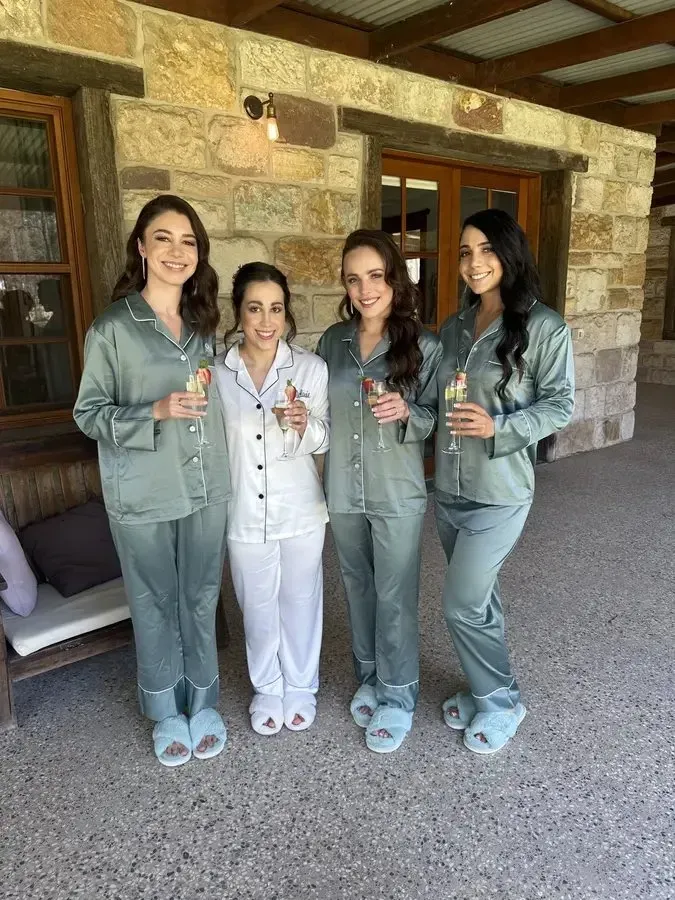 The bride and her bridesmaids in matching pyjamas before hair and makeup begins