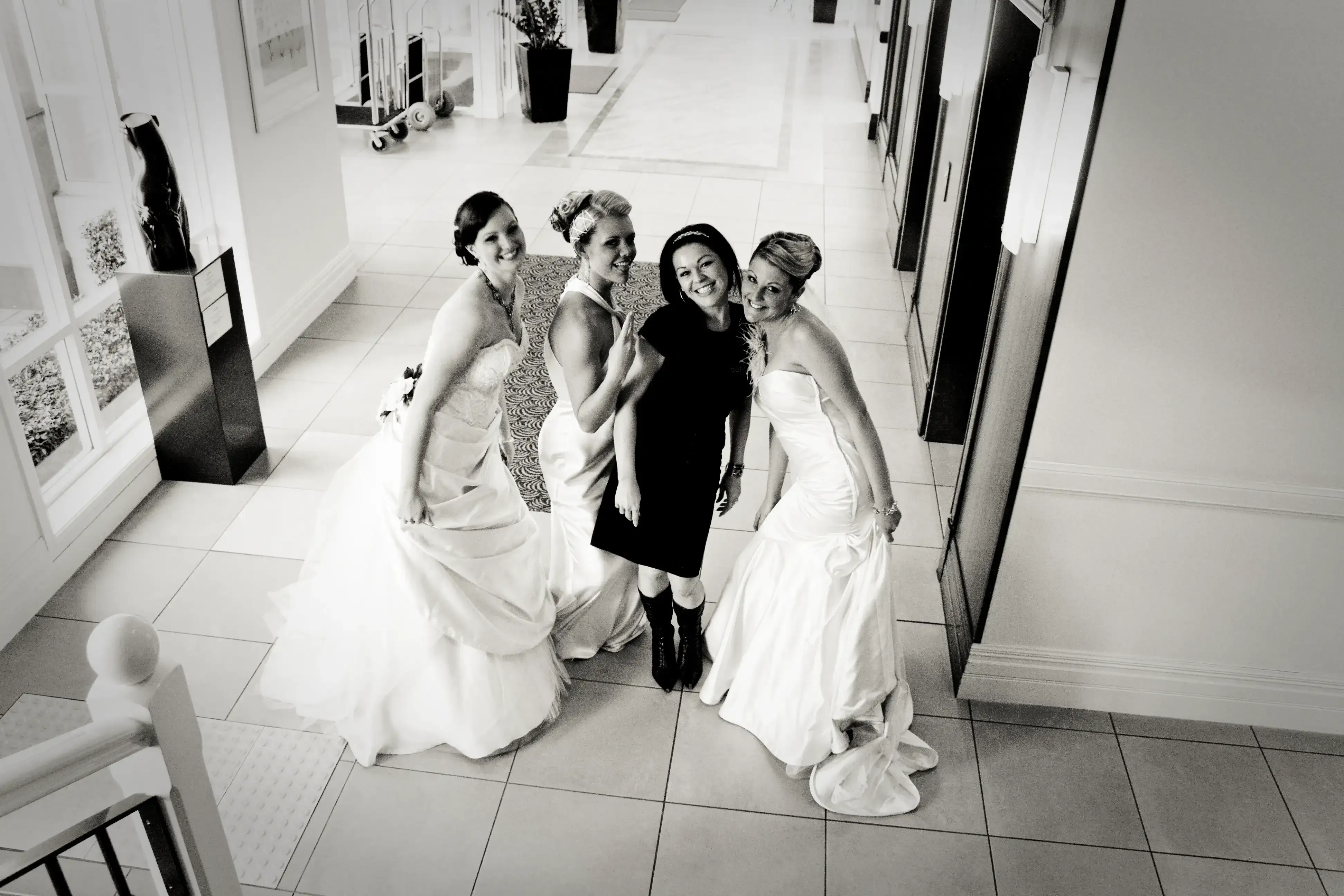 A bridal party photographed in the hallway of their accommodation on the wedding morning