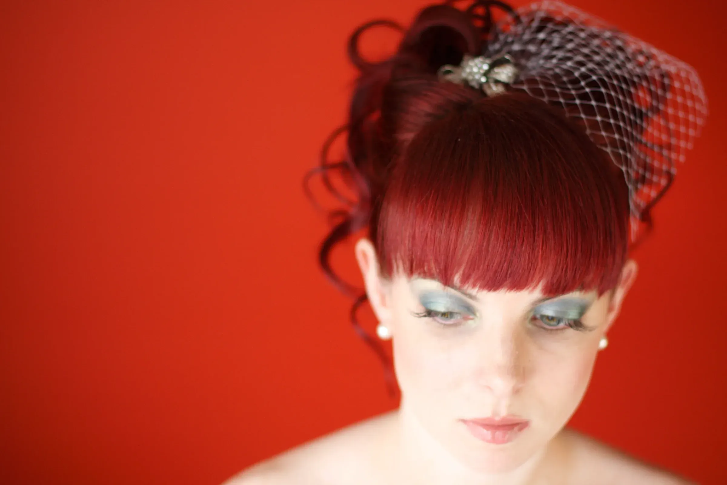 A statement bridal eye photographed against a strong ground, makeup by Amanda Frost