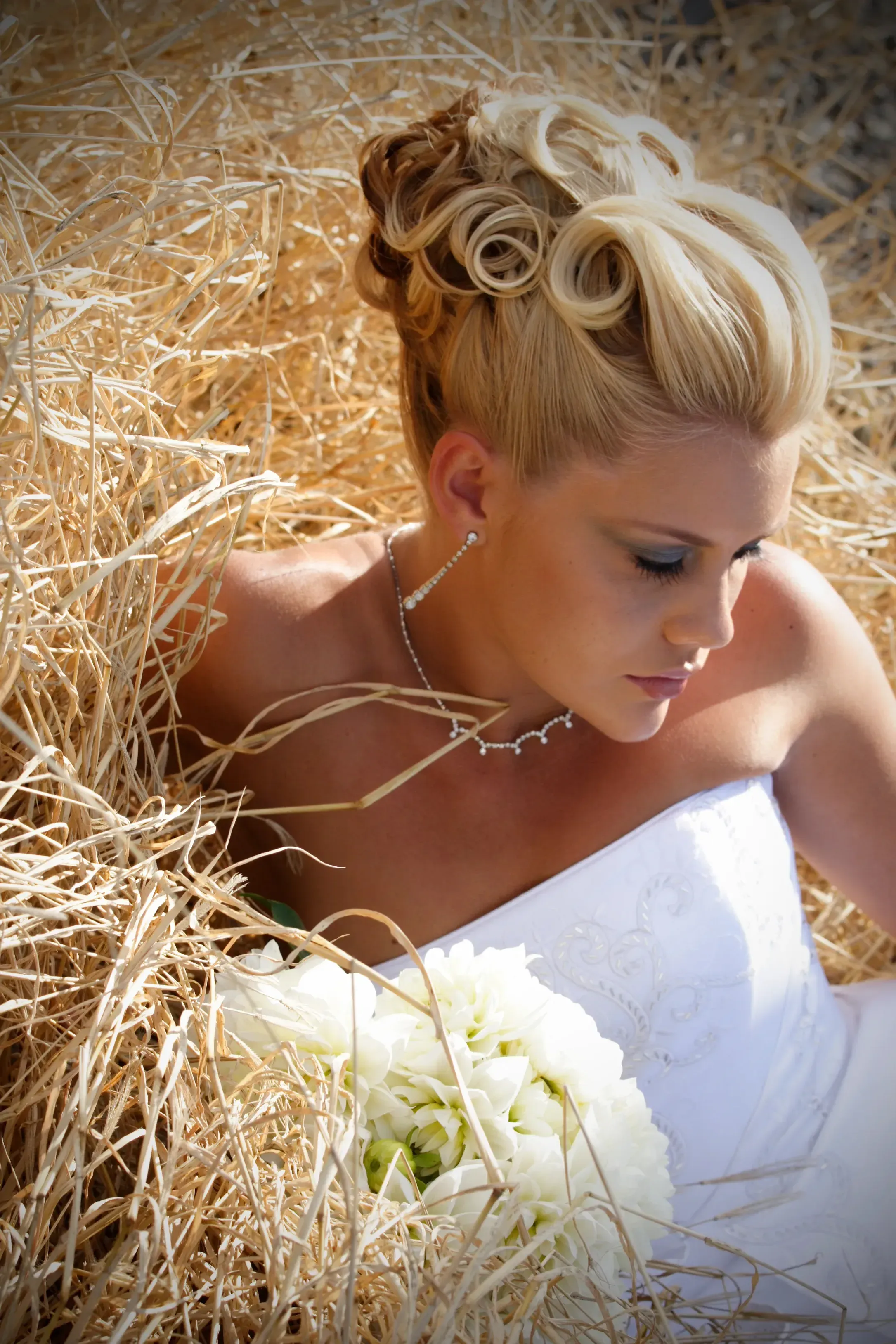 Bride with a sculpted updo, styled on location by Bellus