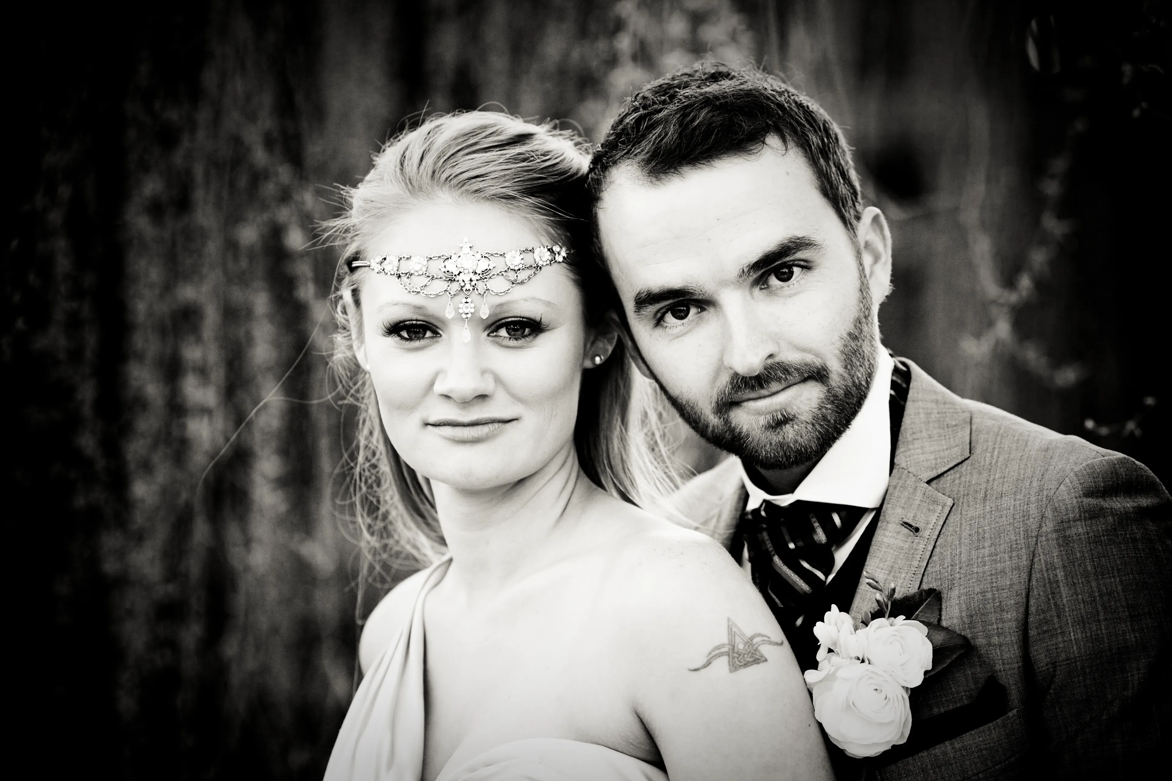 A bride and groom photographed cheek to cheek after the ceremony, hair and makeup by Amanda Frost