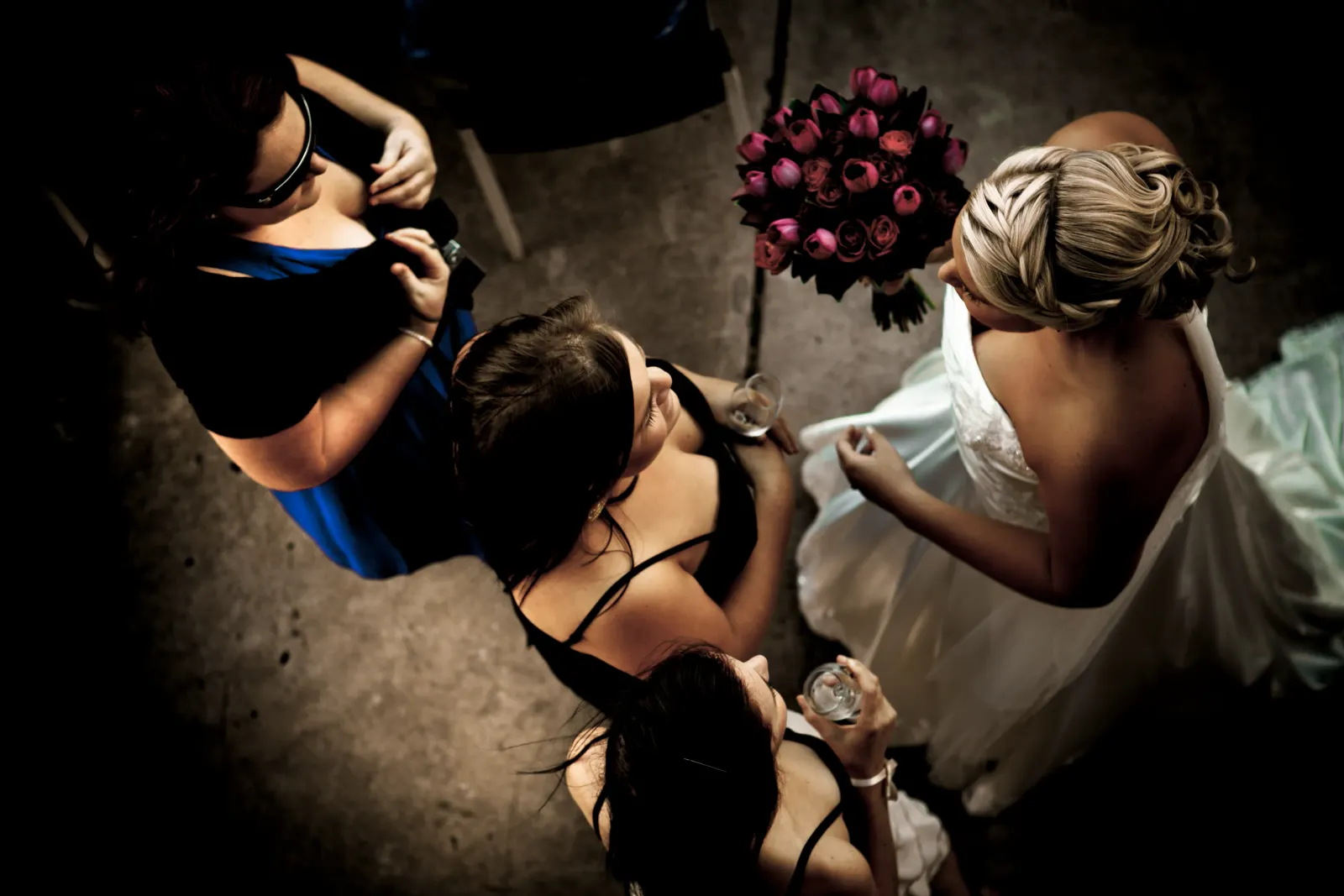Bridesmaids gathering around the bride before a Newcastle wedding, hair by Amanda Frost