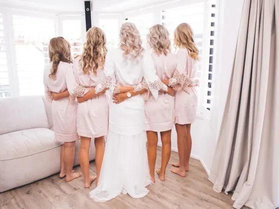 Bridal party hair and makeup, bridesmaids in blush robes on the wedding morning