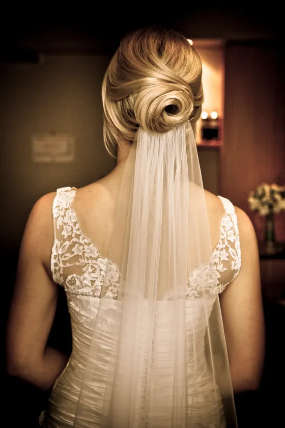 Bridal updo, a sculpted knot worn under a full-length veil